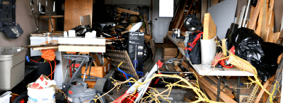 A very cluttered garage in need of a clearance.