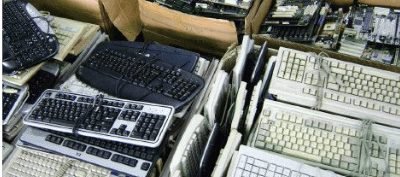 Various office keyboards and equipment that need to be cleared.