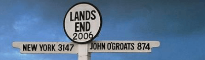 A sign post in Lands end, New York 3147 miles and John o'Groats 874 miles.